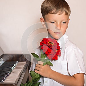 Pianist boy with a bouquet of flowers