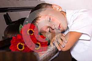 Pianist boy with a bouquet of flowers