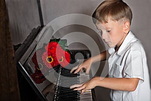 Pianist boy with a bouquet of flowers