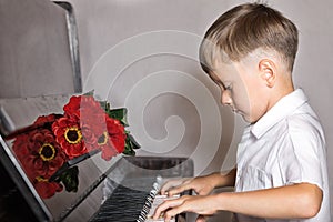 Pianist boy with a bouquet of flowers