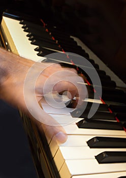 Pianist hand playing a chord, motion action.