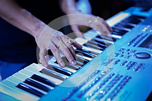 Pianist hand with ring on the piano