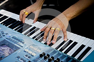 Pianist hand with ring on the piano