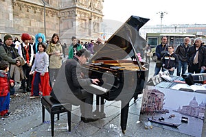 Pianist Paolo Zanarella gives free music street show playing his grand piano at the Duomo of Milan.