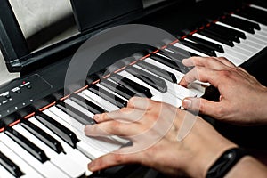 The pianist plays the piano. The pianist`s hands closely. the view from the top .