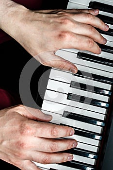 The pianist plays the piano. The pianist`s hands closely. the view from the top .