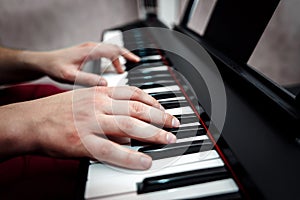 The pianist plays the piano. The pianist`s hands closely. the view from the top .