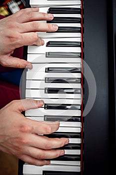 The pianist plays the piano. The pianist`s hands closely. the view from the top .