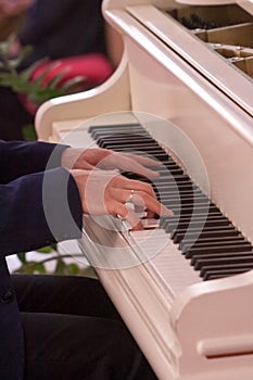 Pianist hands playing classical piano music.