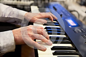 Pianists hands and piano keyboard