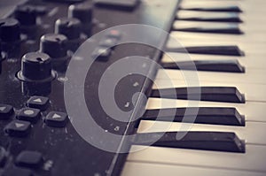 Piano or electone midi keyboard, electronic musical synthesizer white and black key. Vintage effect, instagram filter