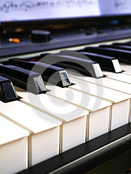 The piano keyboard with black and white keys and notes. Music and sound. photo