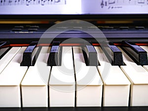 The piano keyboard with black and white keys and notes. Music and sound. photo