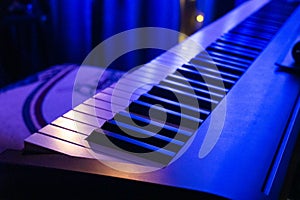 Piano keyboard in concert filled with light. selective focus modern piano, close up, studio light