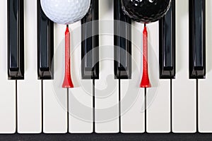 Piano keyboard and different golf balls and tees