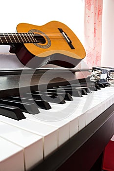 Piano keyboard with guitar and tambourine.