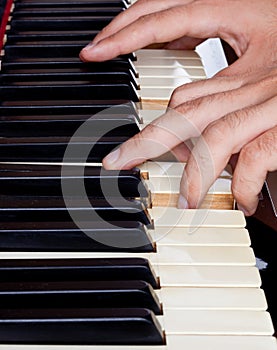 Piano keyboard made of ivory with hands