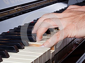 Piano keyboard made of ivory with hands