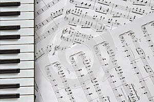 Piano keyboard on music-notes background