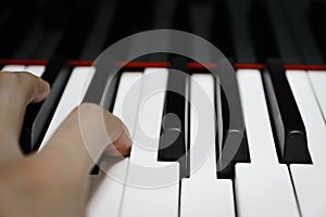 Piano keys on black classical grand piano