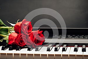 Piano keys and red rose with copy-space