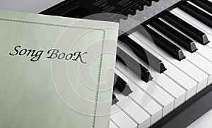 Piano keys and song book