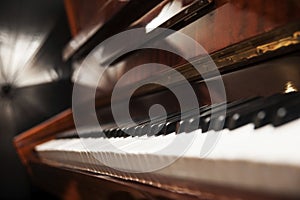 Piano keys on wooden brown musical instrument