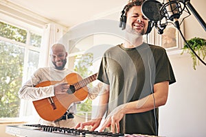 Piano, microphone and friends singing with guitar in home studio together. Electric keyboard, acoustic instrument or