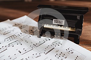 Piano miniture toy on music sheet paper