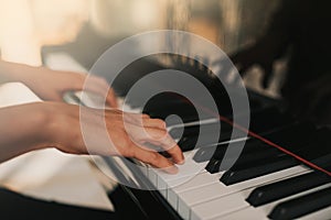 Piano music pianist hands playing. Musical instrument grand piano details with performer hand on white background photo