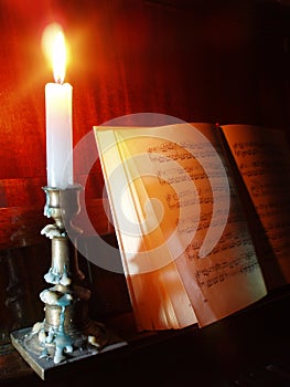 Piano and sheet music in the candle lighting