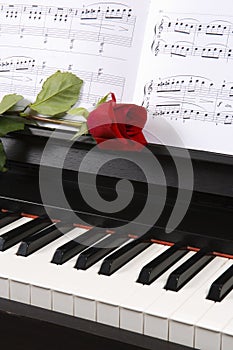 Piano with Sheet Music and a Rose