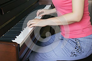 The piano teacher is playing the piano photo
