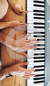 Piano, top view and hands of kid learning with father in home, playing or bonding together. Development, education or