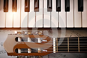 Piano and tuning peg guitar and sheet music background top