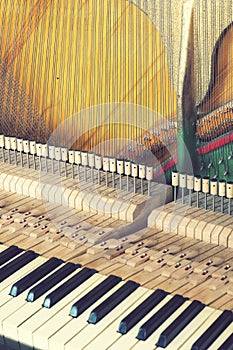 Piano tuning process. closeup of hand and tools of tuner working on grand piano. Detailed view of Upright Piano during a