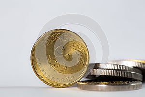 50 piaster Egyptian coin in-front of stack of Egyptian coins