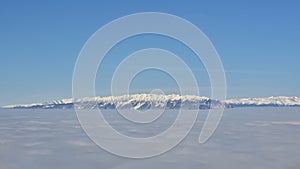 Piatra Craiului winter mountain ridge landscape, panoramic view from Poiana Brasov ski resort.