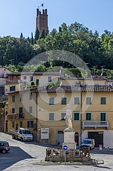 Piazza Buonaparte square in the historic center of San Miniato, Pisa, Italy, dominated by the tower of the Rocca di Federico II