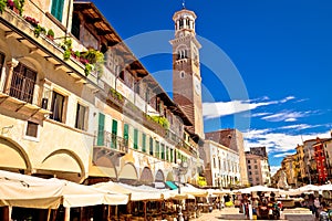 Piazza delle Erbe in Verona street and market view with Lamberti tower