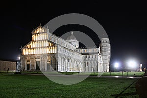 Piazza Miracoli in Pisa seen at night between monuments such as the tower and the solitude of the global pandemic in the dark