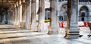 Piazza San Marco loggia with cafe tables photo