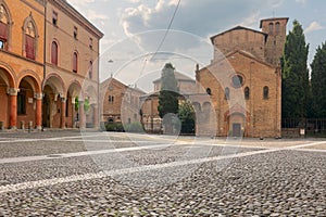 Piazza Santo Stefano. View of the facade of basilica and people walking or standing in the square. Italian summer atmosphere photo