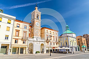 Piazza Tre Martiri Three Martyrs square with traditional buildings with clock and bell tower in Rimini