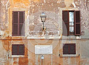 Piazza Trilussa sign in an ancient building in Rome