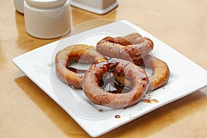 Picarones: These are ring-shaped dessert made with wheat flour dough mixed with pumpkin and sweet potato. fried and dipped in fig photo