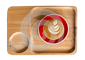 Piccolo Latte art in small glass with red ceramic plate topping beautiful flower art from milk