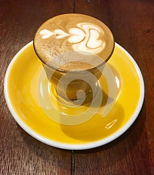 Piccolo latte coffee on yellow plate