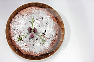 Pice of freshly baked cherry cake on white table background. Overhead view of homemade berry pie.