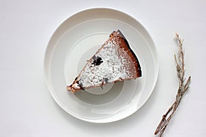 Pice of freshly baked cherry cake on white table background. Overhead view of homemade berry pie.